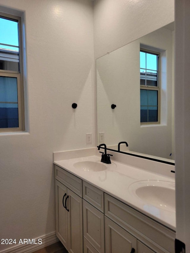 bathroom featuring a wealth of natural light and vanity