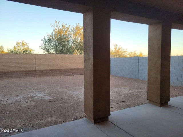 yard at dusk featuring a patio