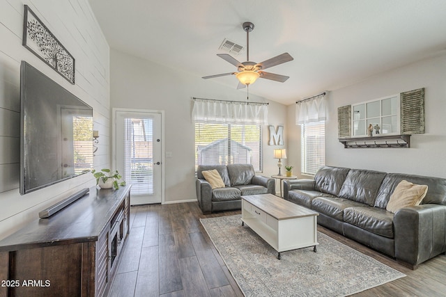 living room featuring hardwood / wood-style flooring, ceiling fan, and vaulted ceiling