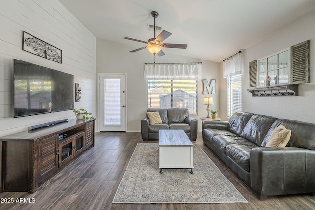 living room featuring ceiling fan, dark hardwood / wood-style flooring, and vaulted ceiling