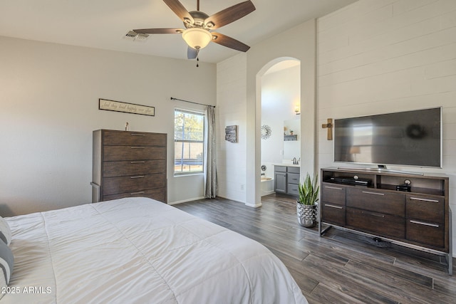 bedroom with ceiling fan, dark hardwood / wood-style floors, and ensuite bathroom