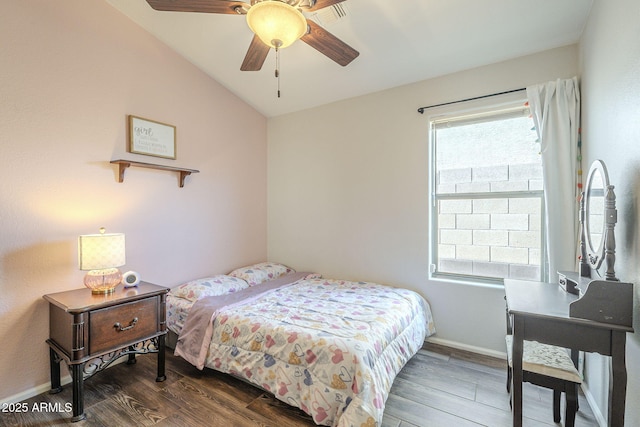 bedroom featuring vaulted ceiling, ceiling fan, and dark wood-type flooring