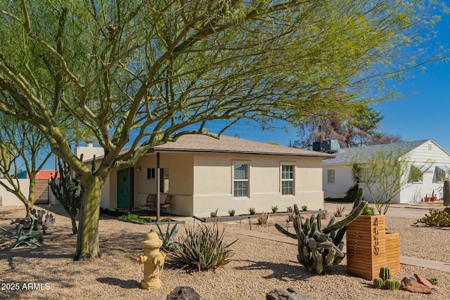 view of front of house featuring stucco siding and central AC