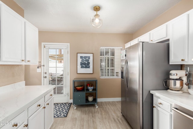 kitchen featuring white cabinetry, stainless steel refrigerator with ice dispenser, and light wood-type flooring