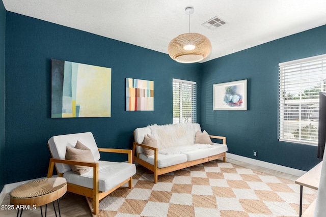 sitting room featuring visible vents and baseboards