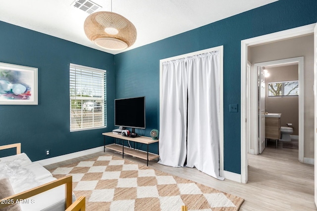 bedroom with multiple windows, baseboards, and visible vents