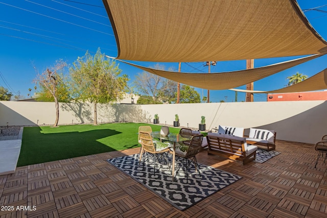 view of patio / terrace with an outdoor living space and a fenced backyard