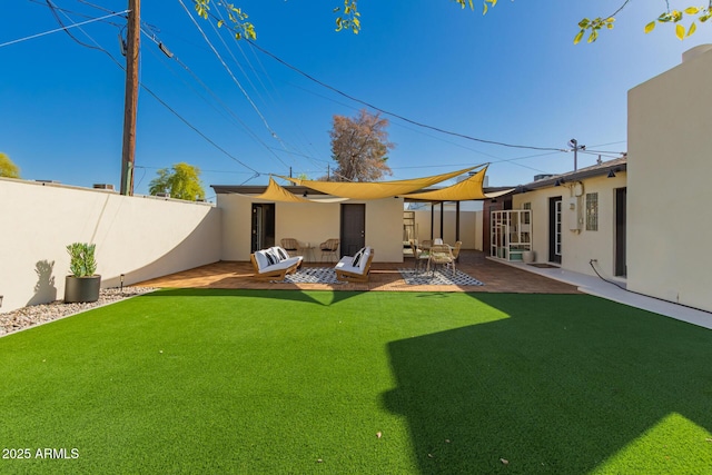 back of property with stucco siding, an outdoor living space, fence, a yard, and a patio area