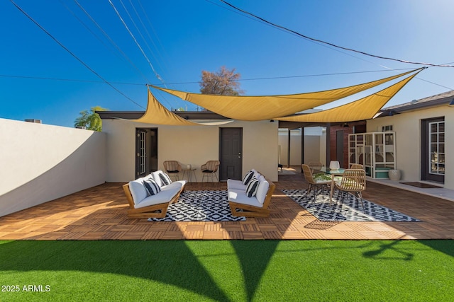 rear view of property featuring a patio area, stucco siding, outdoor lounge area, and fence