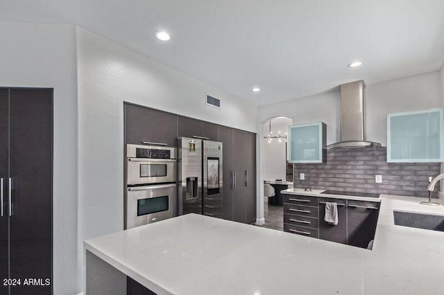 6449 E Paradise Ln, Scottsdale, AZ 85254 - kitchen with wall chimney range hood, appliances with stainless steel finishes, a sink, light countertops, and recessed lighting