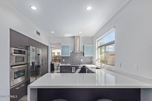 6449 E Paradise Ln, Scottsdale, AZ 85254 - kitchen featuring wall chimney exhaust hood, appliances with stainless steel finishes, a sink, light countertops, and recessed lighting