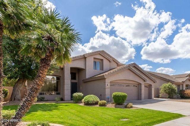 6449 E Paradise Ln, Scottsdale, AZ 85254 - mediterranean / spanish house featuring stucco siding, a garage, concrete driveway, and a front lawn