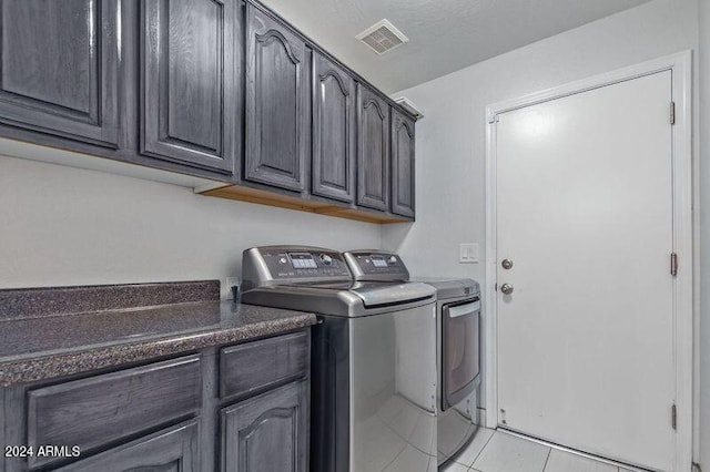6449 E Paradise Ln, Scottsdale, AZ 85254 - washroom with washing machine and dryer, cabinet space, and light tile patterned floors