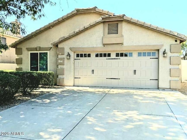 7435 W Trails Dr, Glendale, AZ 85308 - view of front of property featuring a garage, driveway, stucco siding, and a tile roof