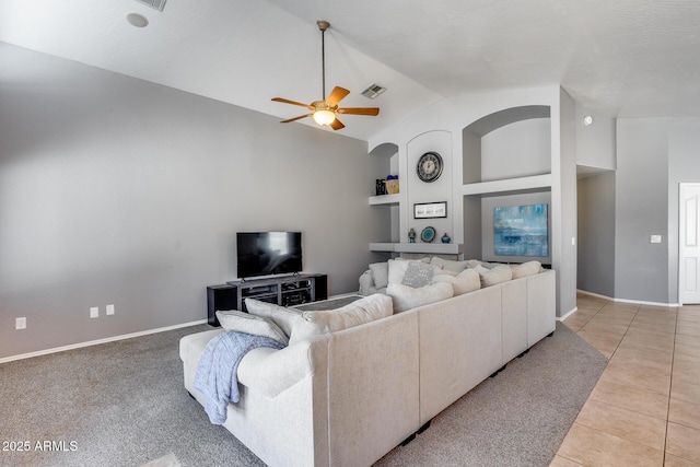 7435 W Trails Dr, Glendale, AZ 85308 - living room with a ceiling fan, built in features, vaulted ceiling, and light tile patterned floors