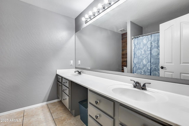7435 W Trails Dr, Glendale, AZ 85308 - bathroom featuring double vanity, a textured wall, and tile patterned floors