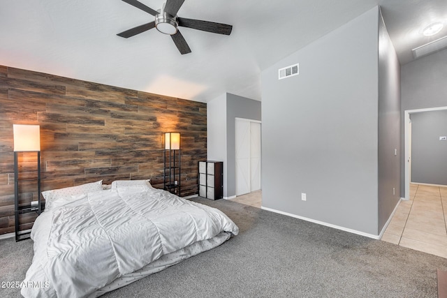7435 W Trails Dr, Glendale, AZ 85308 - bedroom featuring high vaulted ceiling, wooden walls, carpet floors, an accent wall, and tile patterned flooring