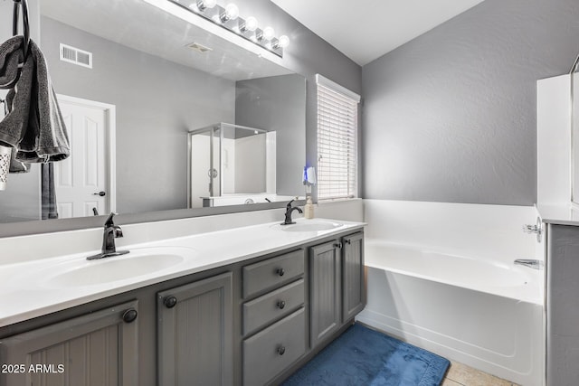 7435 W Trails Dr, Glendale, AZ 85308 - bathroom featuring a garden tub, double vanity, a stall shower, and tile patterned floors