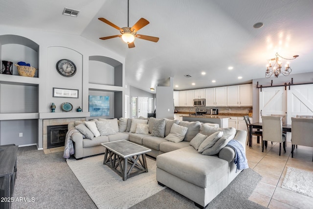 7435 W Trails Dr, Glendale, AZ 85308 - living area with lofted ceiling, a tiled fireplace, a ceiling fan, a chandelier, and recessed lighting