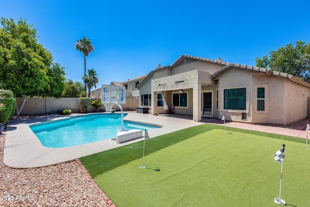 7435 W Trails Dr, Glendale, AZ 85308 - view of swimming pool with a putting green, a patio area, a fenced backyard, and a water slide