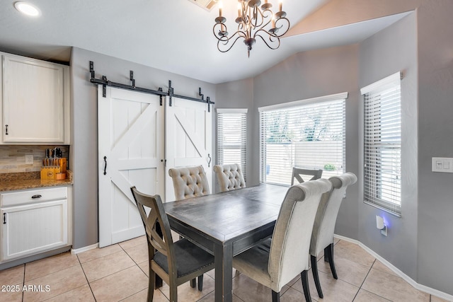 7435 W Trails Dr, Glendale, AZ 85308 - dining space featuring a barn door, light tile patterned floors, lofted ceiling, and a chandelier