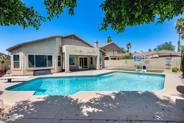 7435 W Trails Dr, Glendale, AZ 85308 - view of swimming pool with a patio area, a fenced backyard, a ceiling fan, and a diving board
