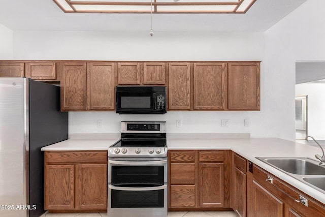 kitchen featuring sink, light tile patterned floors, and stainless steel appliances