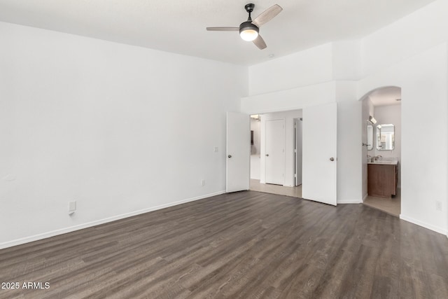 unfurnished room featuring ceiling fan and dark hardwood / wood-style flooring