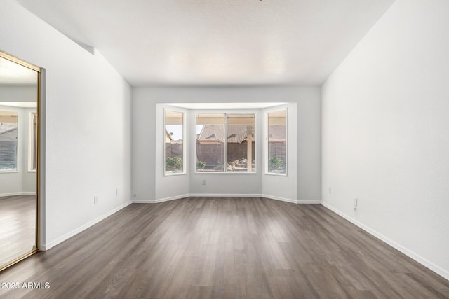 unfurnished room with dark hardwood / wood-style floors