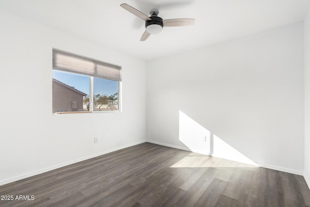 spare room featuring dark hardwood / wood-style floors and ceiling fan