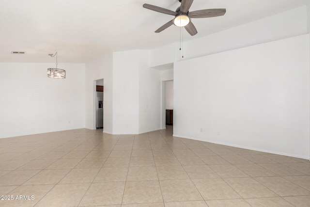 unfurnished room with ceiling fan and light tile patterned floors