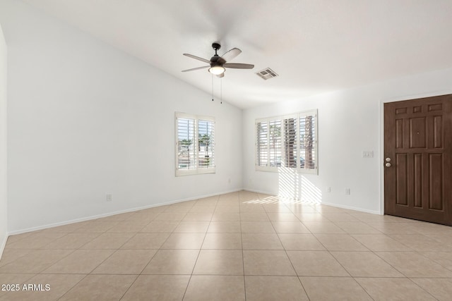 tiled empty room with lofted ceiling and ceiling fan