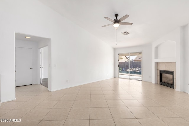 unfurnished living room featuring a tile fireplace, light tile patterned flooring, high vaulted ceiling, and ceiling fan