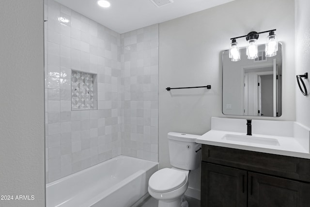 full bathroom featuring vanity, toilet, and tiled shower / bath combo