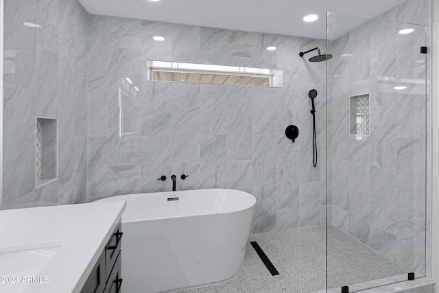 bathroom featuring sink, tile walls, and shower with separate bathtub