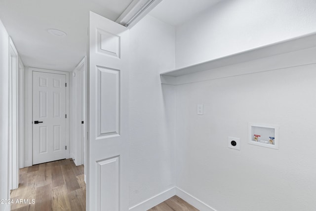 laundry area featuring hookup for an electric dryer, hookup for a washing machine, and light hardwood / wood-style flooring