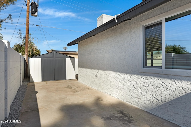 view of side of home featuring a storage unit