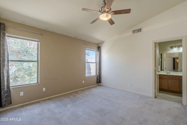 8660 E Nido Ave, Mesa, AZ 85209 - unfurnished bedroom featuring lofted ceiling, multiple windows, light colored carpet, connected bathroom, and ceiling fan