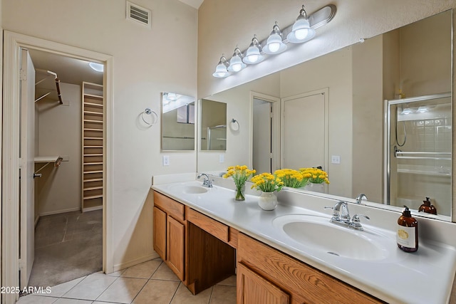 8660 E Nido Ave, Mesa, AZ 85209 - bathroom featuring double vanity, a walk in closet, tile patterned floors, and a shower stall