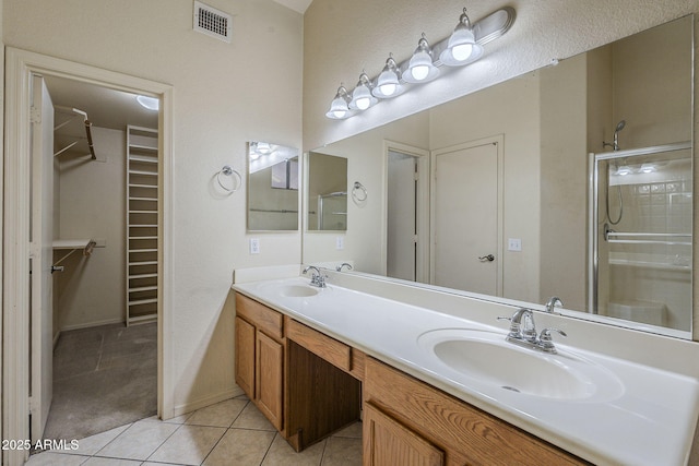 8660 E Nido Ave, Mesa, AZ 85209 - full bath with double vanity, a walk in closet, tile patterned flooring, and a stall shower