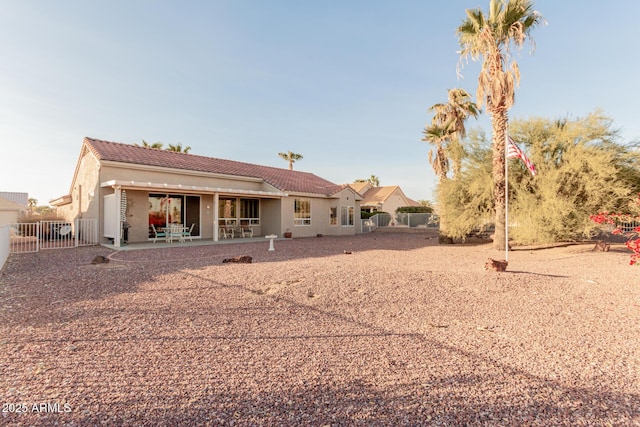 back of property featuring a patio area