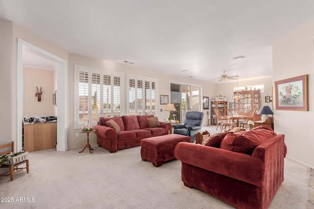 carpeted living room with ceiling fan