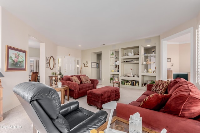 living room featuring built in features and light colored carpet