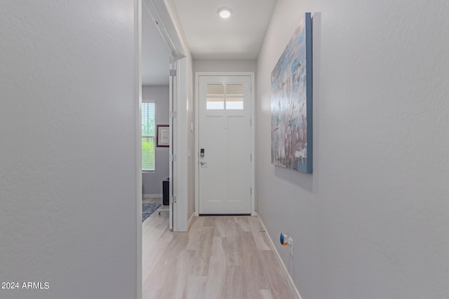 doorway with light wood-type flooring