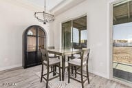 dining area featuring light hardwood / wood-style floors and a chandelier