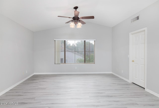 empty room with ceiling fan, light hardwood / wood-style floors, and lofted ceiling