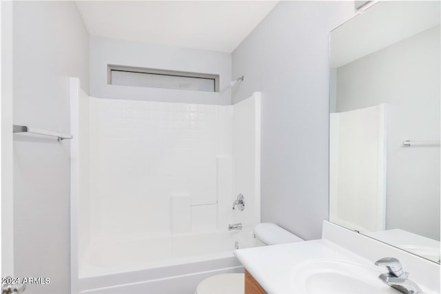 full bathroom featuring vanity, toilet, and washtub / shower combination