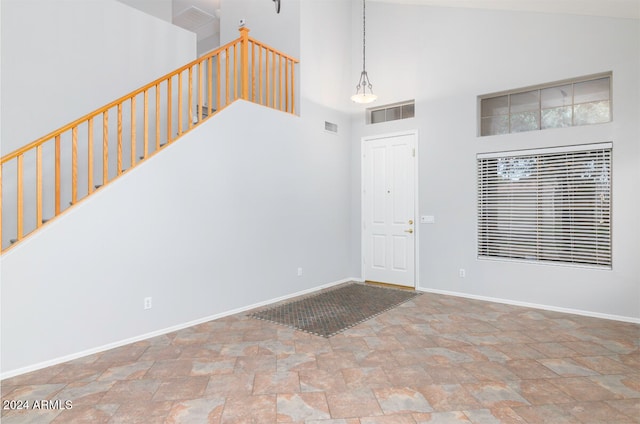 entrance foyer with high vaulted ceiling