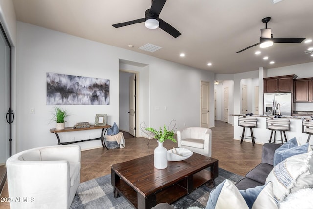 living area with tile patterned flooring, recessed lighting, a ceiling fan, and visible vents