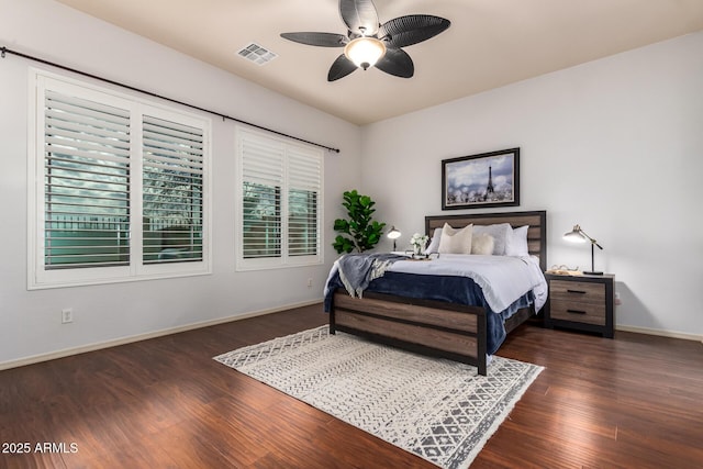 bedroom featuring visible vents, a ceiling fan, baseboards, and wood finished floors